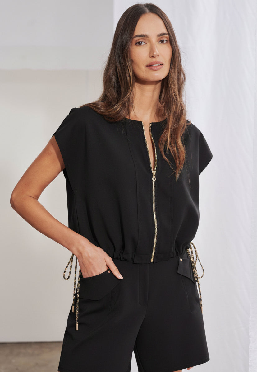 Short de alfaiataria feminino com cós anatômico e bolsos tipo faca com lapela. As costas revelam cós com elástico franzido embutido e dois bolsos chapados geométricos com rebites metálicos nos cantos superiores.